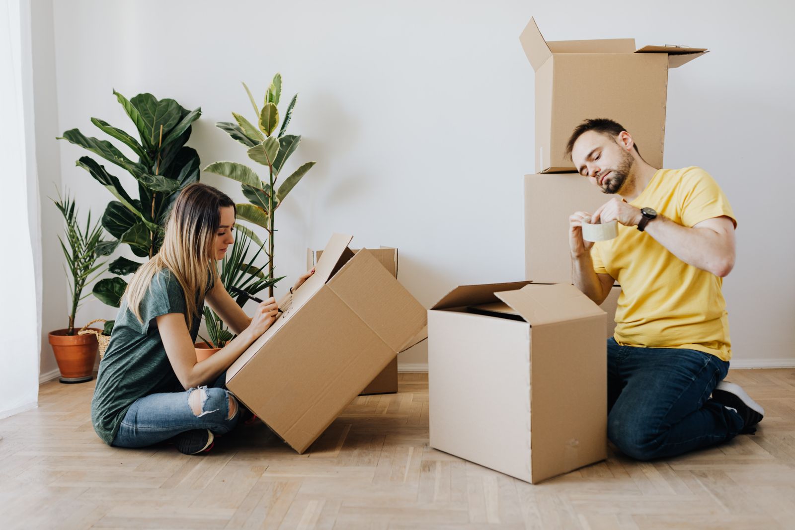 Couple unpacking boxes in their new living room